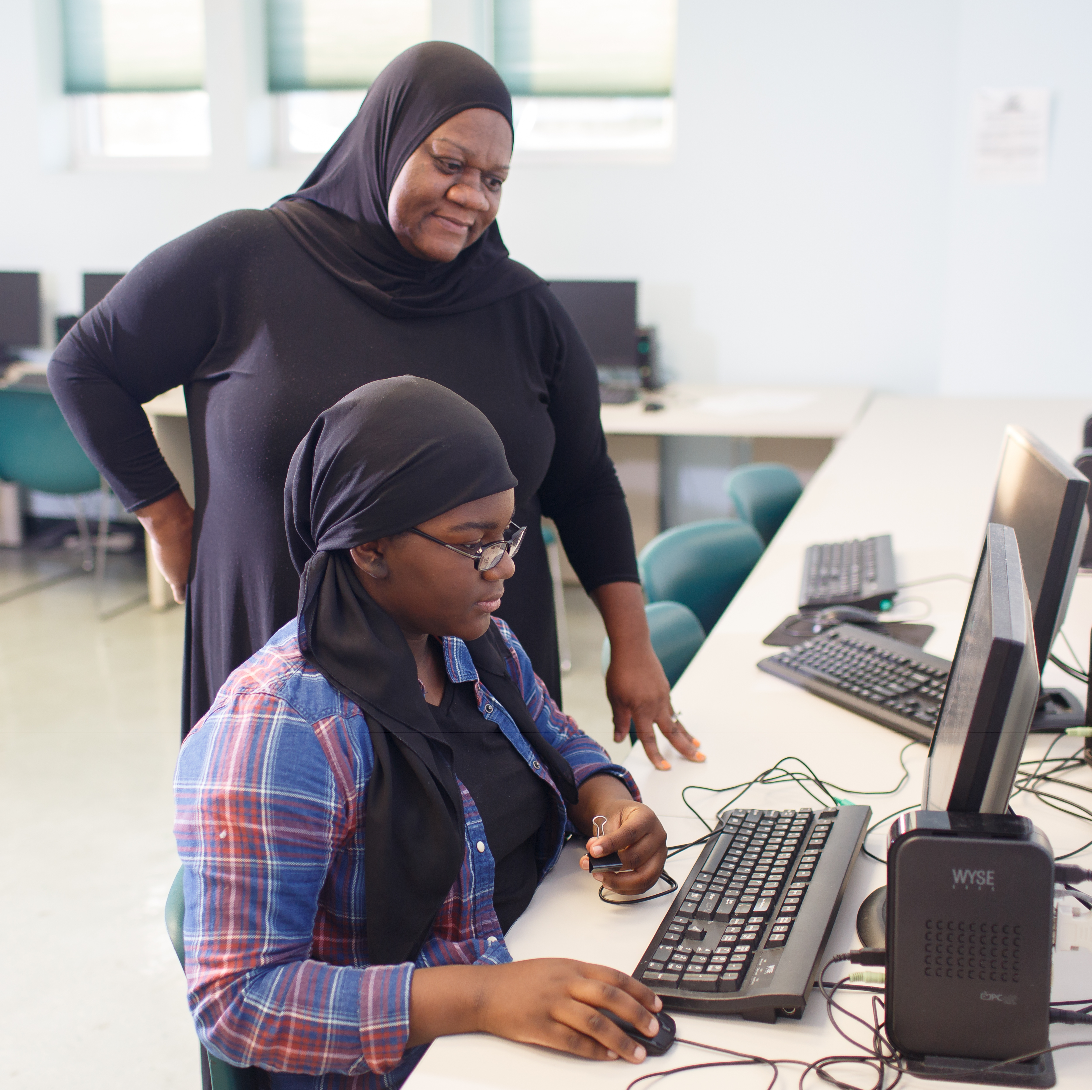 Mother and daughter at computer at St. Barnabas Mission 600x600-1